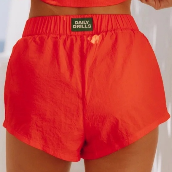 DAILY DRILLS ORANGE SHORTS - Picture 1 of 7